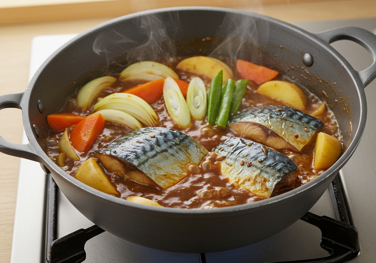 A photo showing the cooking process in a pot: simmering the vegetables and mackerel with the curry roux and Japanese seasonings, showing a rich, slightly thickened sauce.